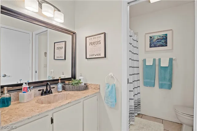 a bathroom with a sink mirror and vanity