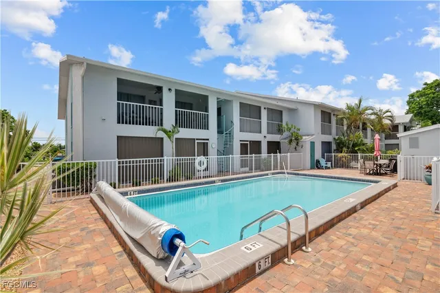 a view of a house with swimming pool and sitting area