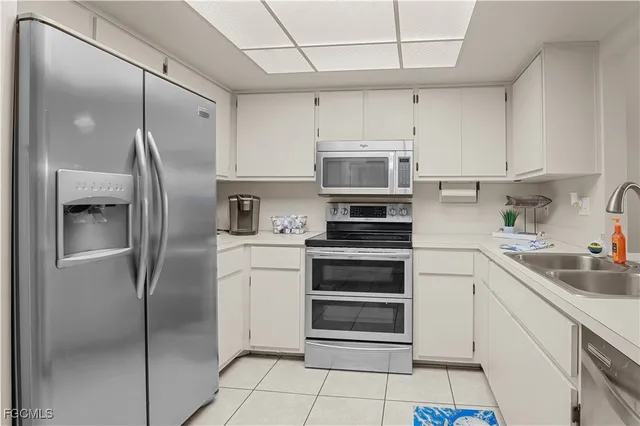 a kitchen with cabinets stainless steel appliances and a counter space