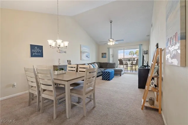 a view of a dining room with furniture and chandelier