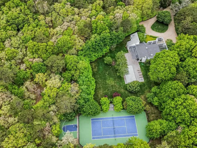 an aerial view of a house with a yard