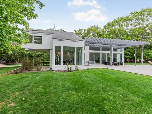 front view of a house with a yard and potted plants