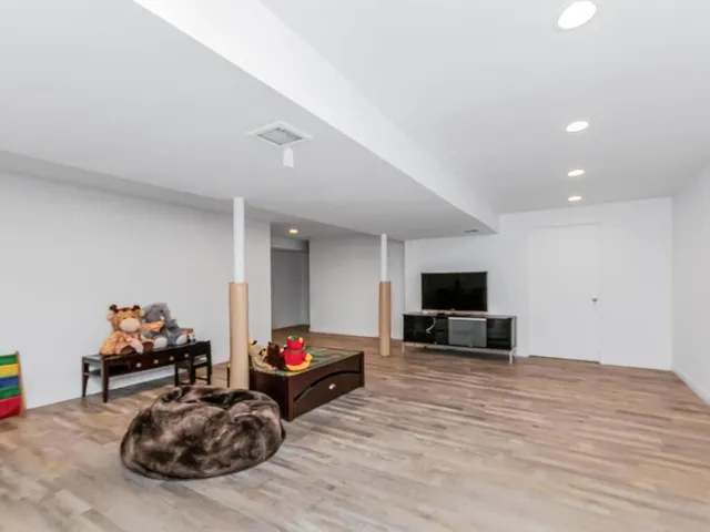 a view of a room with wooden floor and window