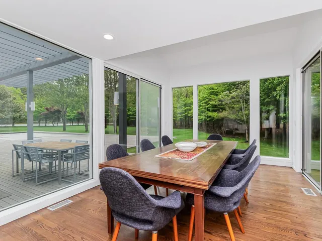 a view of a dining room with furniture window and wooden floor