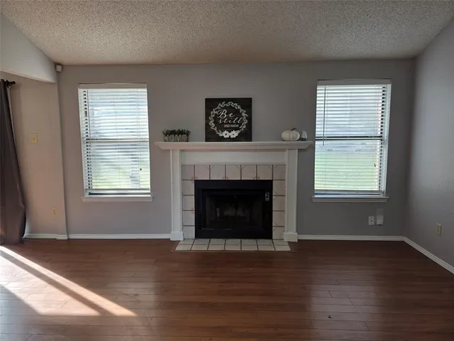 a living room with a fireplace and a window