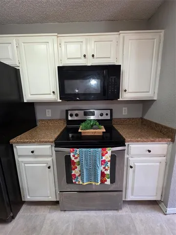 a stove top oven sitting inside of a kitchen