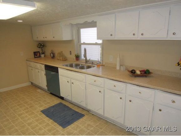 428 Beech Grove Road Roseland, VA 22967 - Photo 5 of 18 a kitchen with granite countertop white cabinets and sink