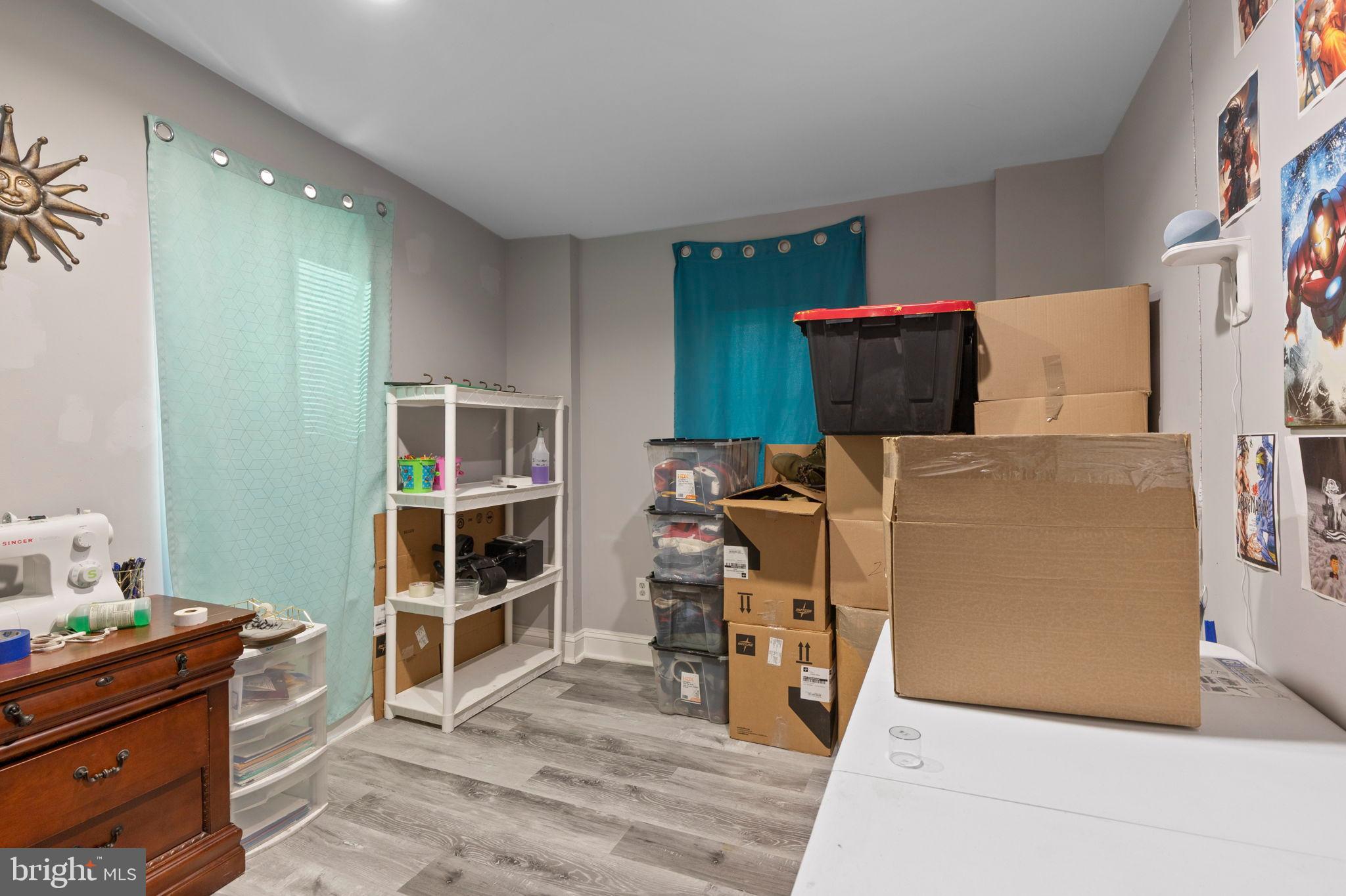 406 South Smallwood Street Baltimore, MD 21223 - Photo 11 of 18 a room with furniture and a flat screen tv