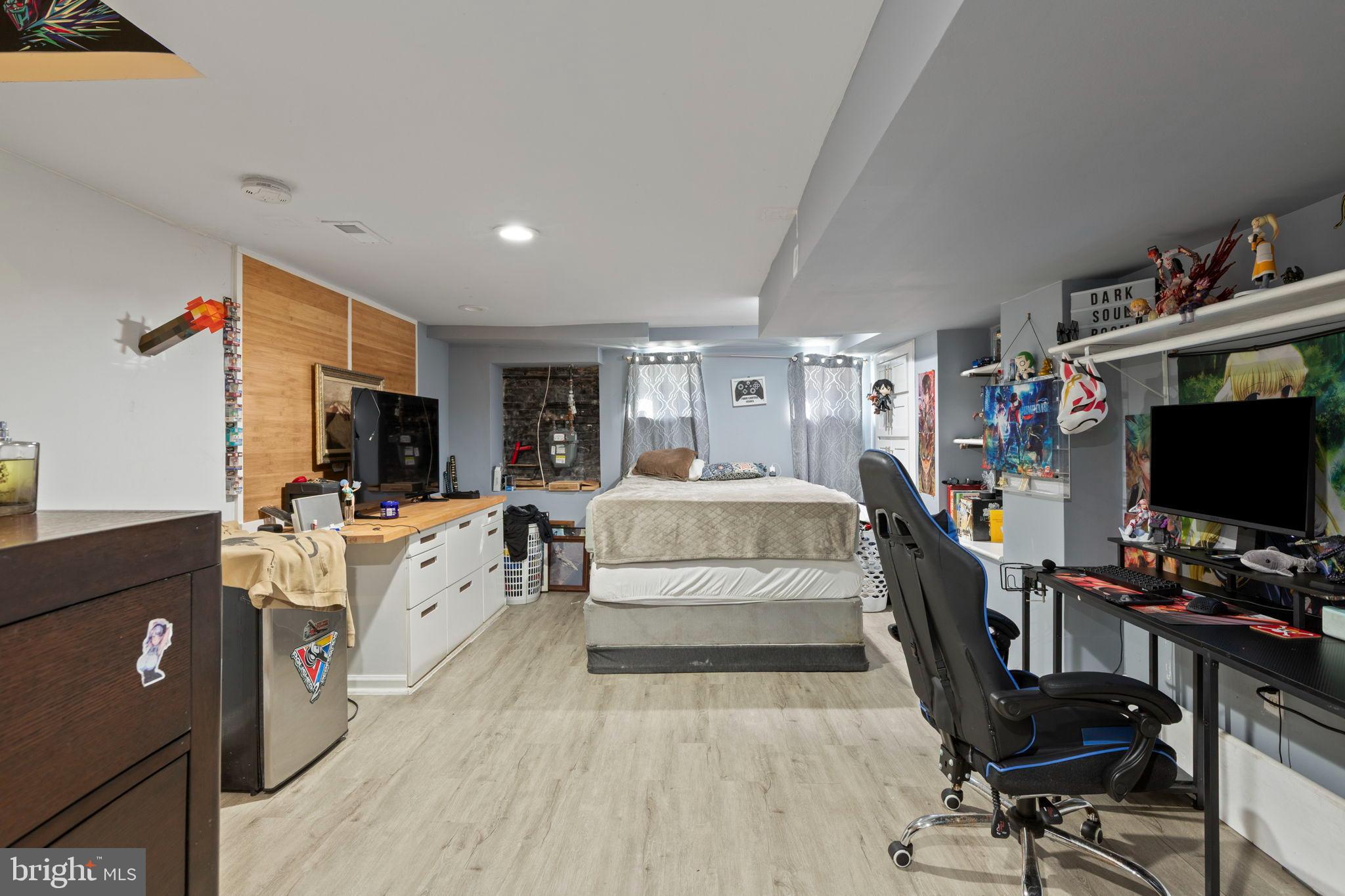 406 South Smallwood Street Baltimore, MD 21223 - Photo 13 of 18 a bed room with furniture and a flat screen tv