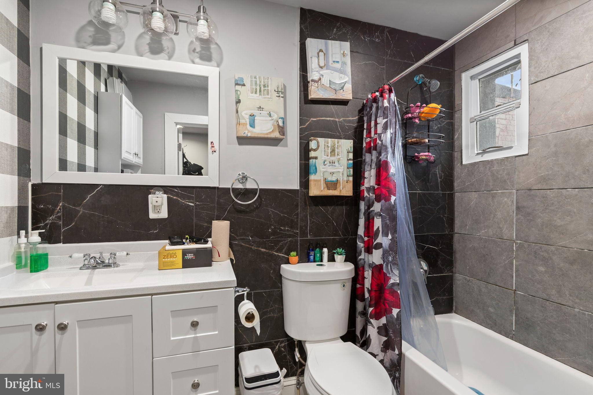 406 South Smallwood Street Baltimore, MD 21223 - Photo 6 of 18 a bathroom with a sink a toilet and shower