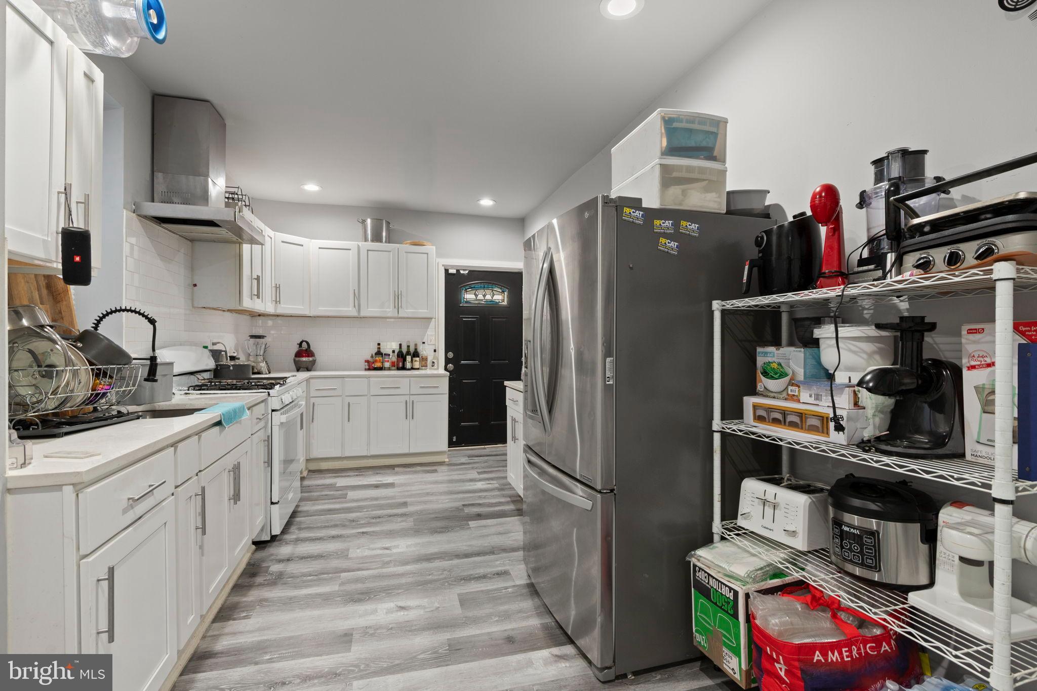 406 South Smallwood Street Baltimore, MD 21223 - Photo 8 of 18 a kitchen with refrigerator and cabinets