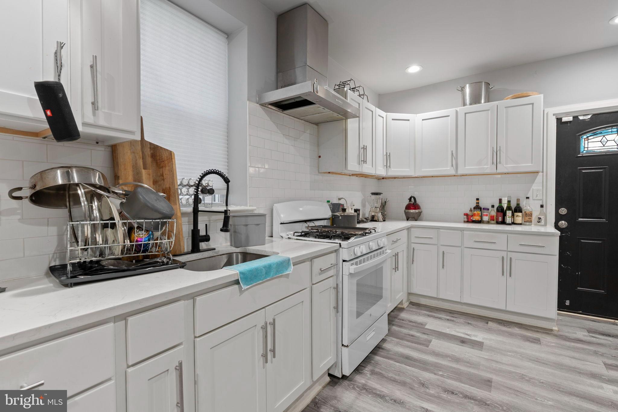 406 South Smallwood Street Baltimore, MD 21223 - Photo 9 of 18 a kitchen with white cabinets and appliances
