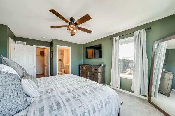 a bedroom with a large bed and a flat screen tv
