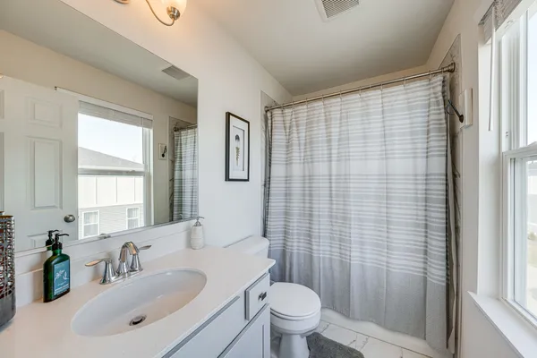 a en suite bathroom with a double vanity sink a mirror and a shower