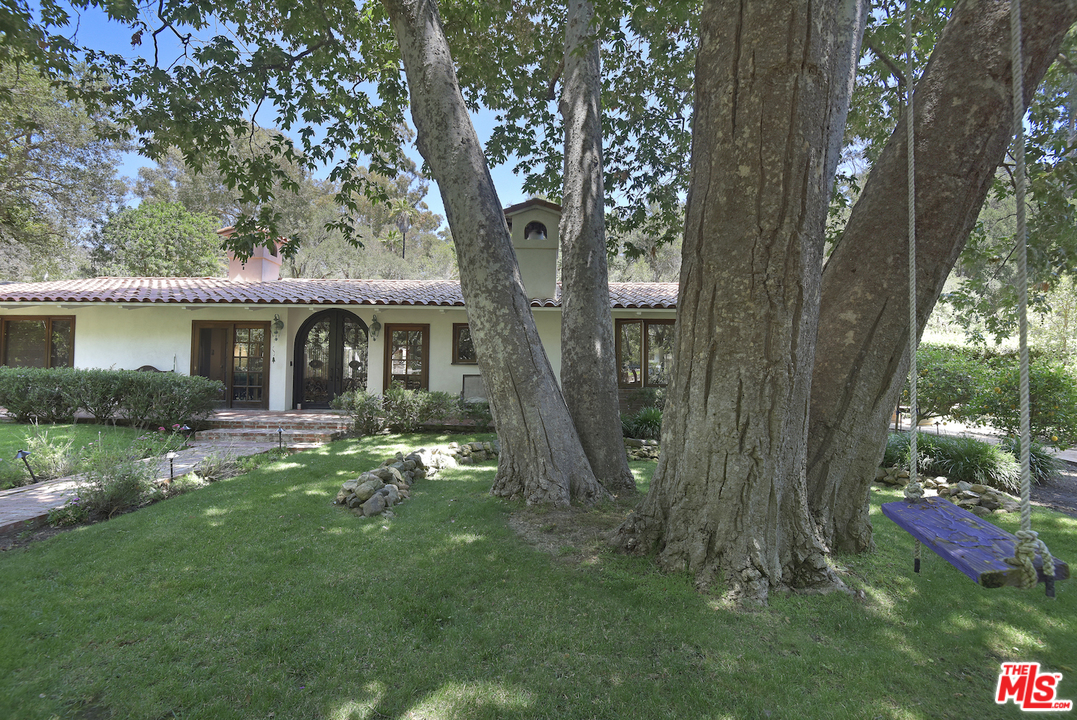6138 Ramirez Canyon Road Malibu, CA 90265 - Photo 2 of 42 a view of a house with a yard