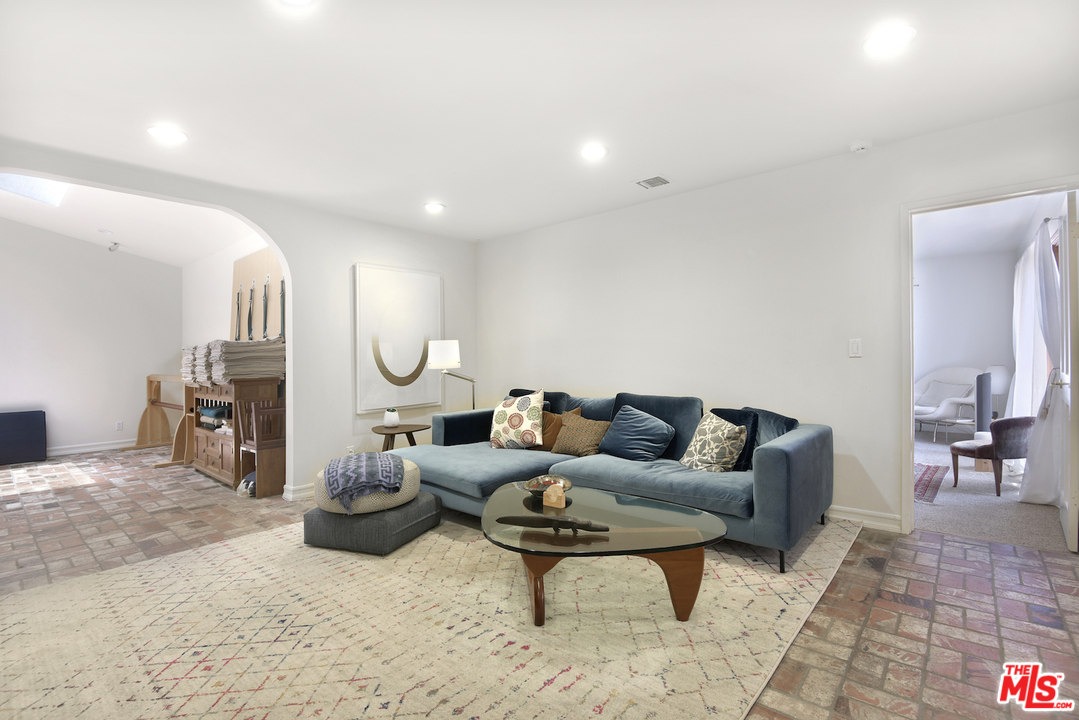 6138 Ramirez Canyon Road Malibu, CA 90265 - Photo 16 of 42 a living room with furniture a rug and a table