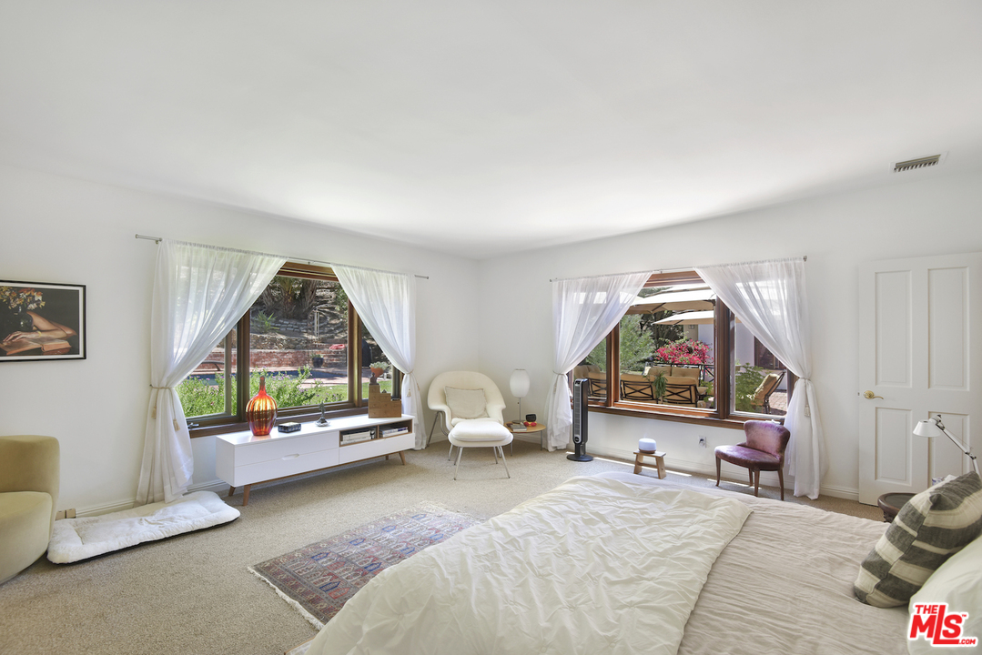 6138 Ramirez Canyon Road Malibu, CA 90265 - Photo 21 of 42 a bedroom with furniture and a window