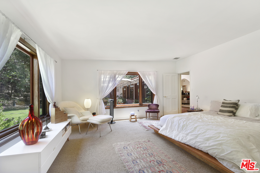 6138 Ramirez Canyon Road Malibu, CA 90265 - Photo 22 of 42 a bedroom with a bed and window