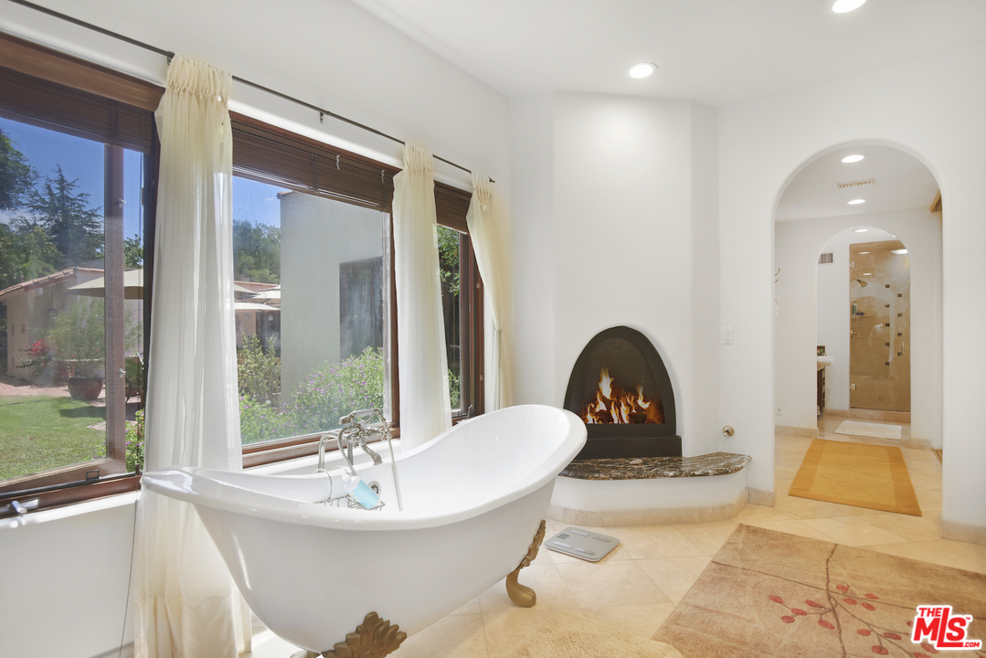 6138 Ramirez Canyon Road Malibu, CA 90265 - Photo 25 of 42 a bathroom with a sink a toilet and a mirror
