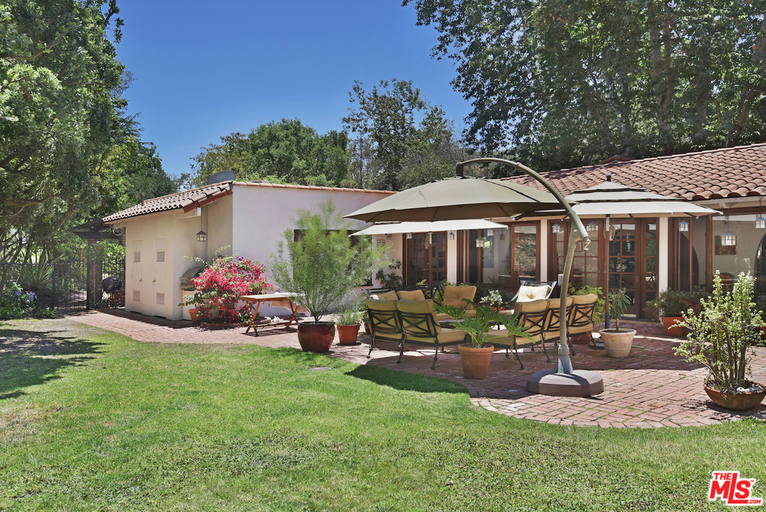 6138 Ramirez Canyon Road Malibu, CA 90265 - Photo 31 of 42 a view of a house with backyard porch and sitting area