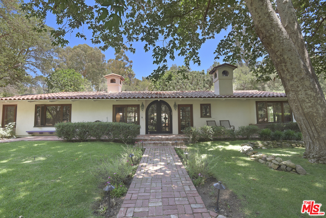 6138 Ramirez Canyon Road Malibu, CA 90265 - Photo 32 of 42 front view of a house with a yard