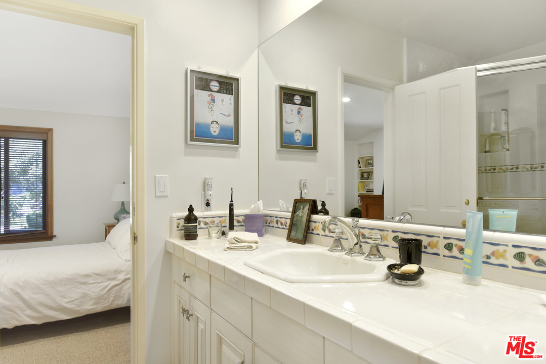 6138 Ramirez Canyon Road Malibu, CA 90265 - Photo 36 of 42 a bathroom with double vanity sinks and a mirror