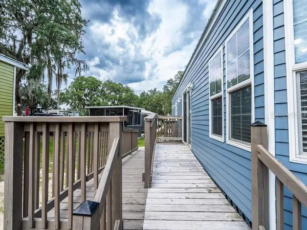 a view of a house with wooden deck