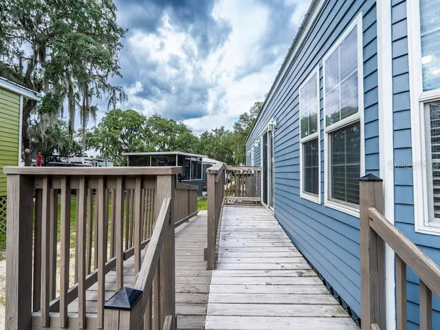 a view of a house with wooden deck