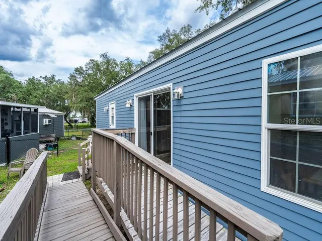 a view of a house with wooden deck