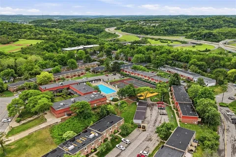 an aerial view of residential houses with outdoor space and street view