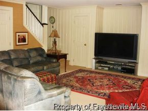 301 Summertime Road Fayetteville, NC 28303 - Photo 12 of 25 a living room with furniture and a flat screen tv