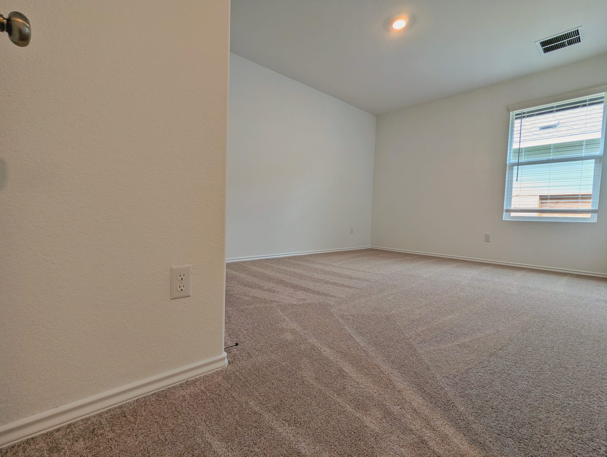 1504 Marley Kyle, TX 78640 - Photo 16 of 28 Empty room with light colored carpet and baseboards
