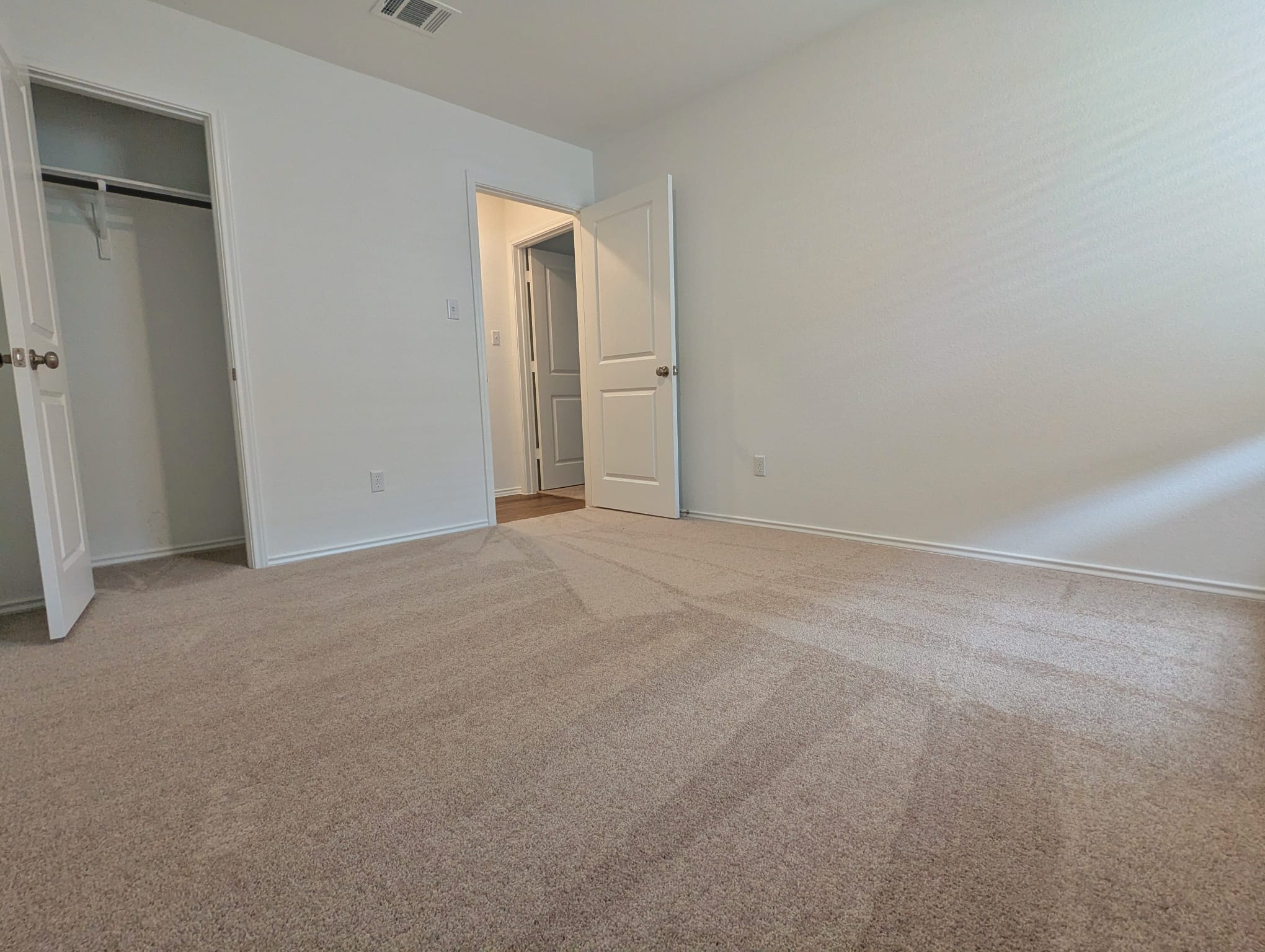 1504 Marley Kyle, TX 78640 - Photo 19 of 28 Unfurnished bedroom featuring light colored carpet and a closet