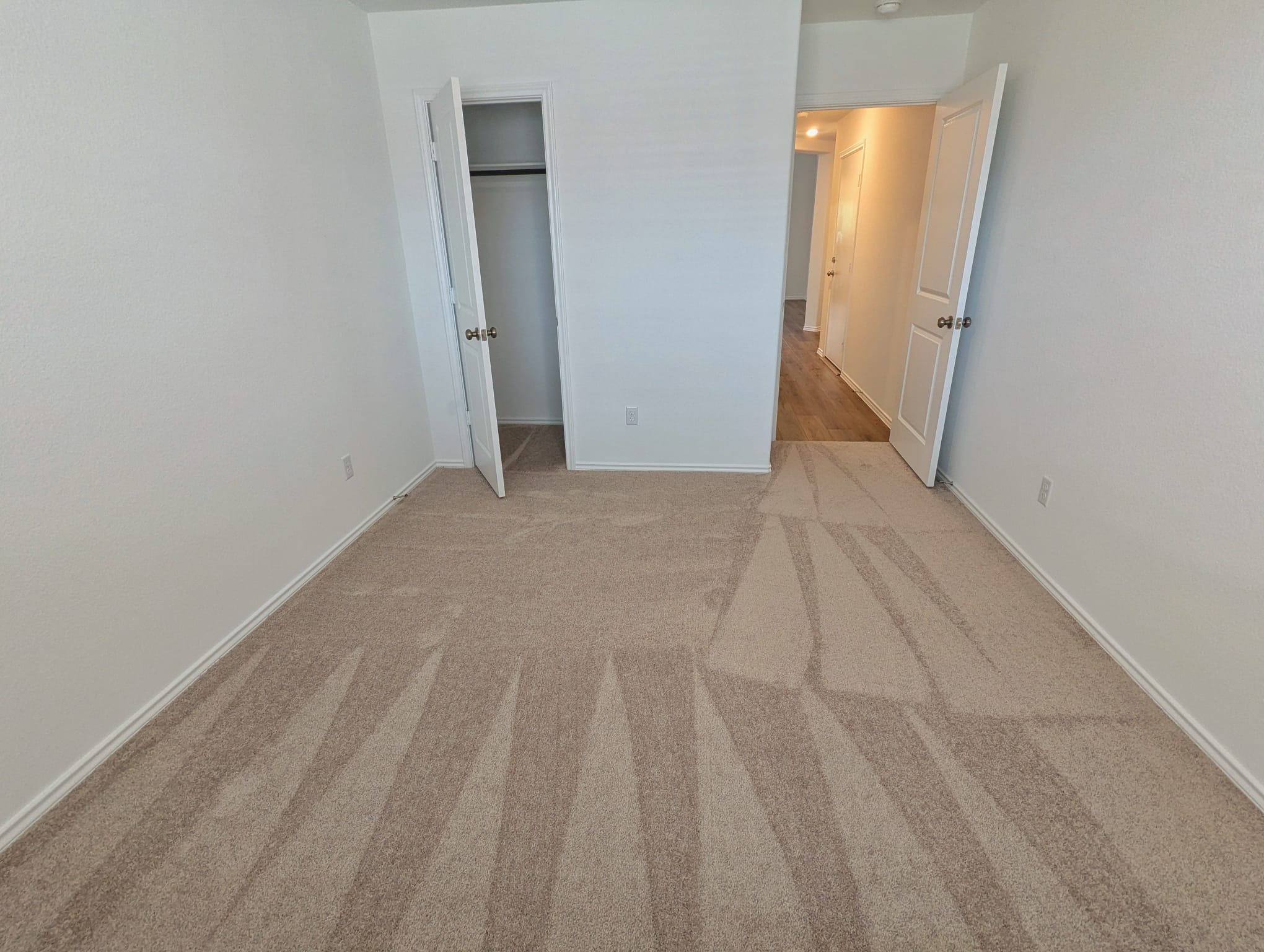1504 Marley Kyle, TX 78640 - Photo 22 of 28 Unfurnished bedroom with light colored carpet and a closet