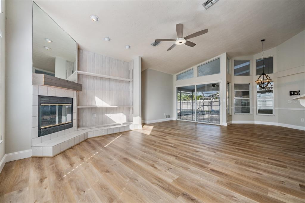 5315 Saltamonte Drive New Port Richey, FL 34655 - Photo 11 of 26 a view of a livingroom with wooden floor a ceiling fan and windows