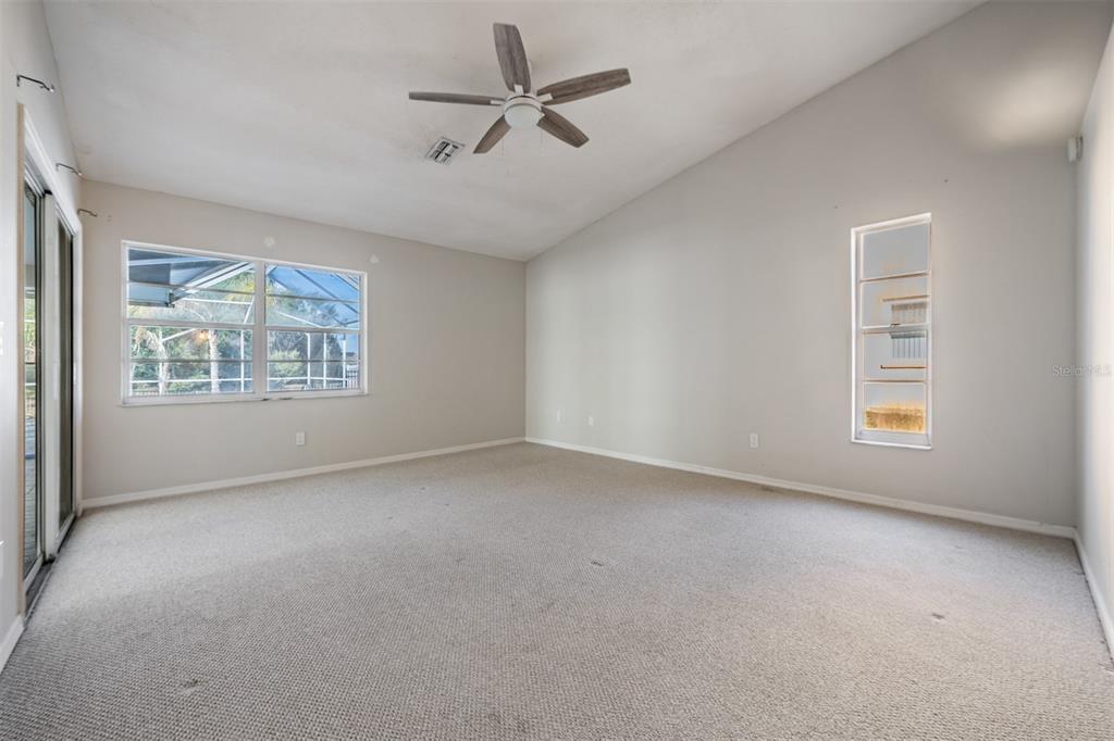 5315 Saltamonte Drive New Port Richey, FL 34655 - Photo 15 of 26 an empty room with windows and ceiling fan