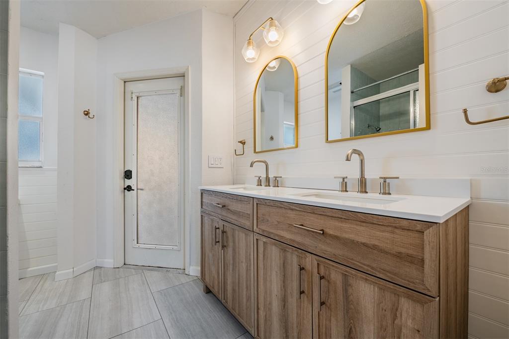 5315 Saltamonte Drive New Port Richey, FL 34655 - Photo 19 of 26 a bathroom with a double vanity sink and mirror