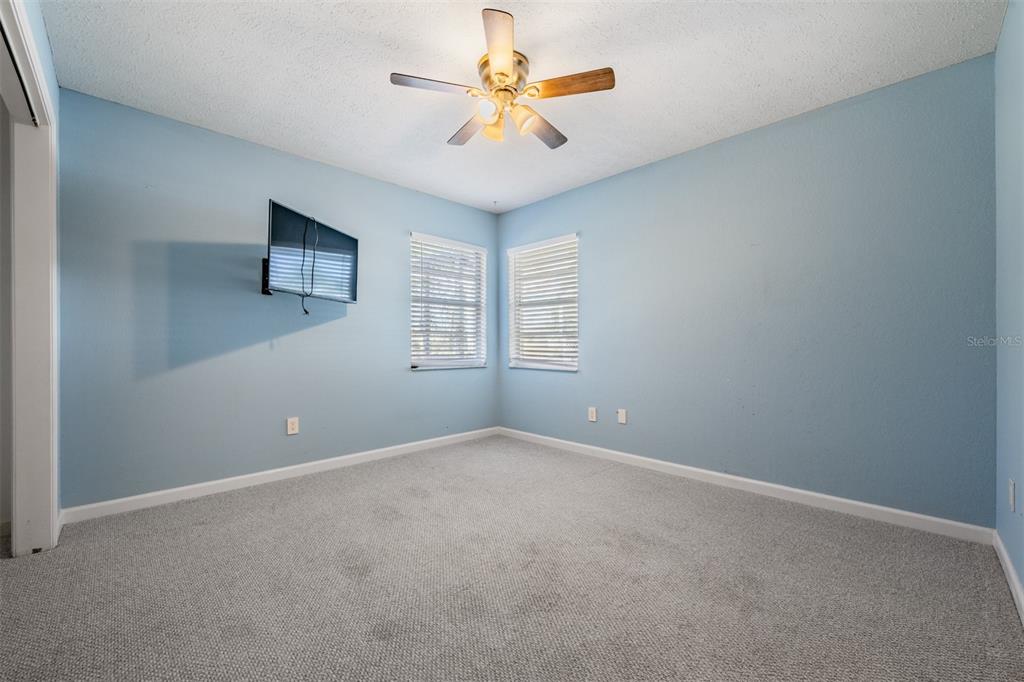 5315 Saltamonte Drive New Port Richey, FL 34655 - Photo 20 of 26 an empty room with windows and chandelier fan