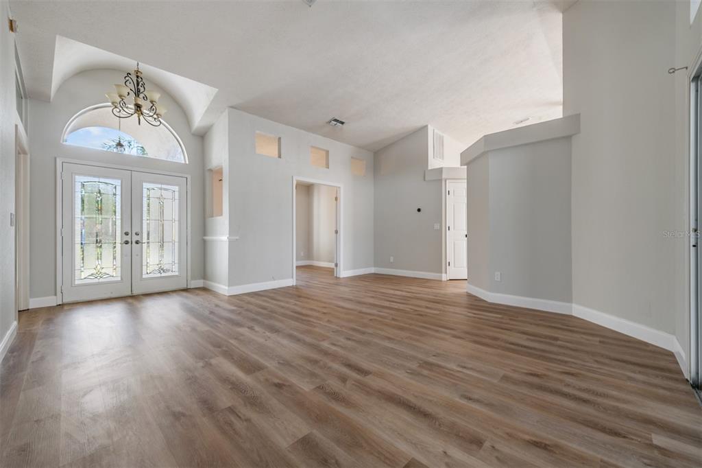 5315 Saltamonte Drive New Port Richey, FL 34655 - Photo 3 of 26 a view of an empty room with wooden floor and a window