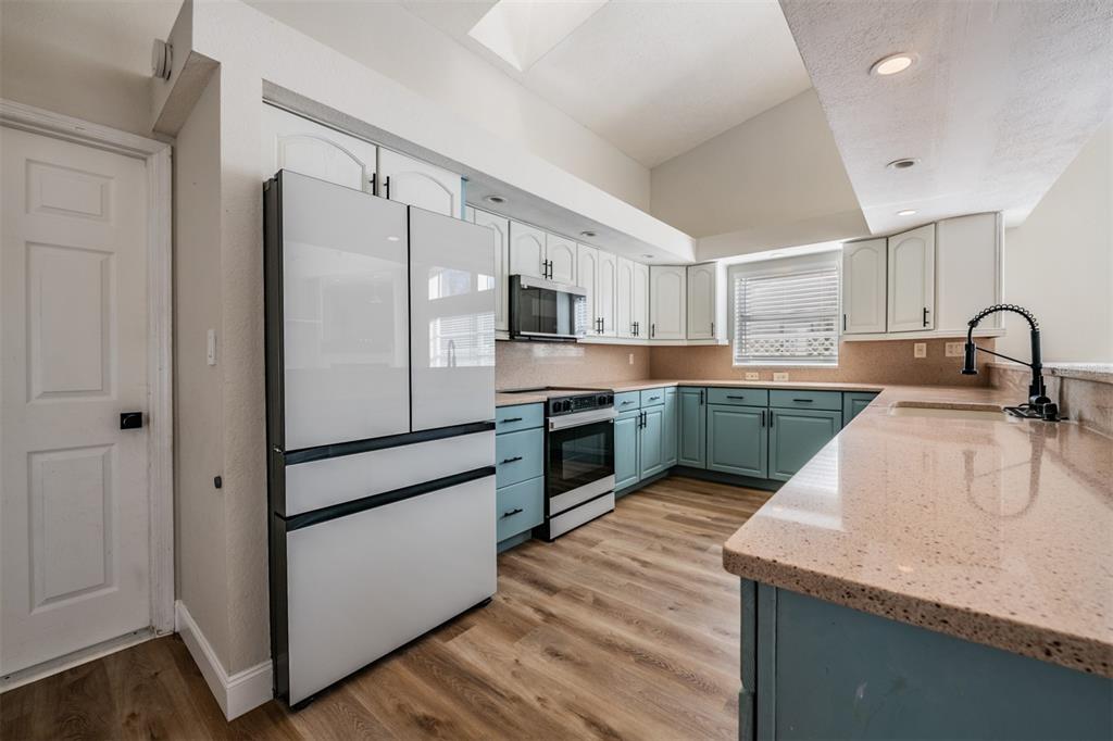 5315 Saltamonte Drive New Port Richey, FL 34655 - Photo 9 of 26 a kitchen with kitchen island a sink stainless steel appliances and window