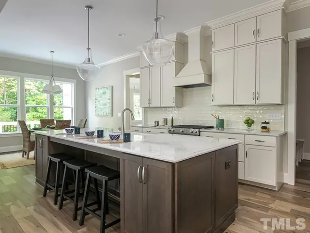 a kitchen with a sink a window stainless steel appliances and cabinets