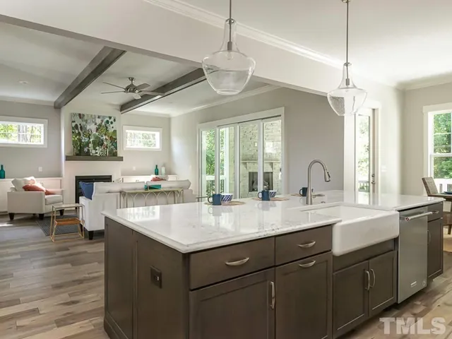 a open kitchen with a sink stove and wooden floor