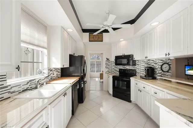 a kitchen with stainless steel appliances granite countertop a sink and cabinets