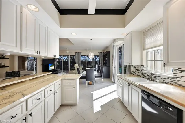 a living room with furniture and a view of kitchen