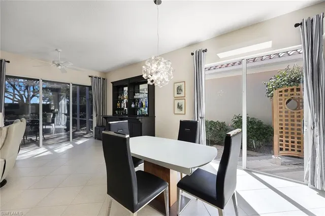 a view of a dining room with furniture and chandelier