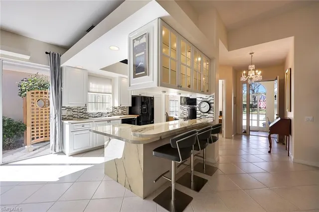a kitchen with stainless steel appliances granite countertop a sink and cabinets