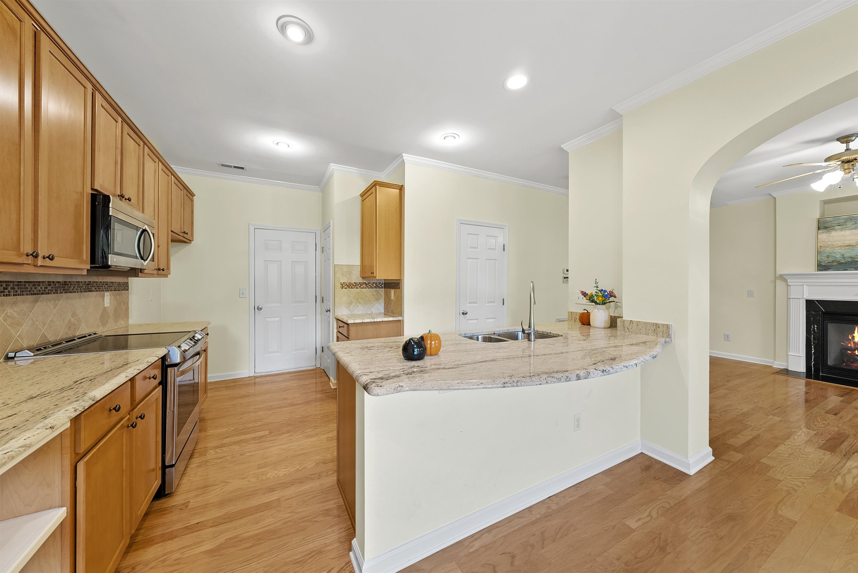 8408 Tie Stone Way Raleigh, NC 27613 - Photo 14 of 33 a kitchen with a sink stove and cabinets