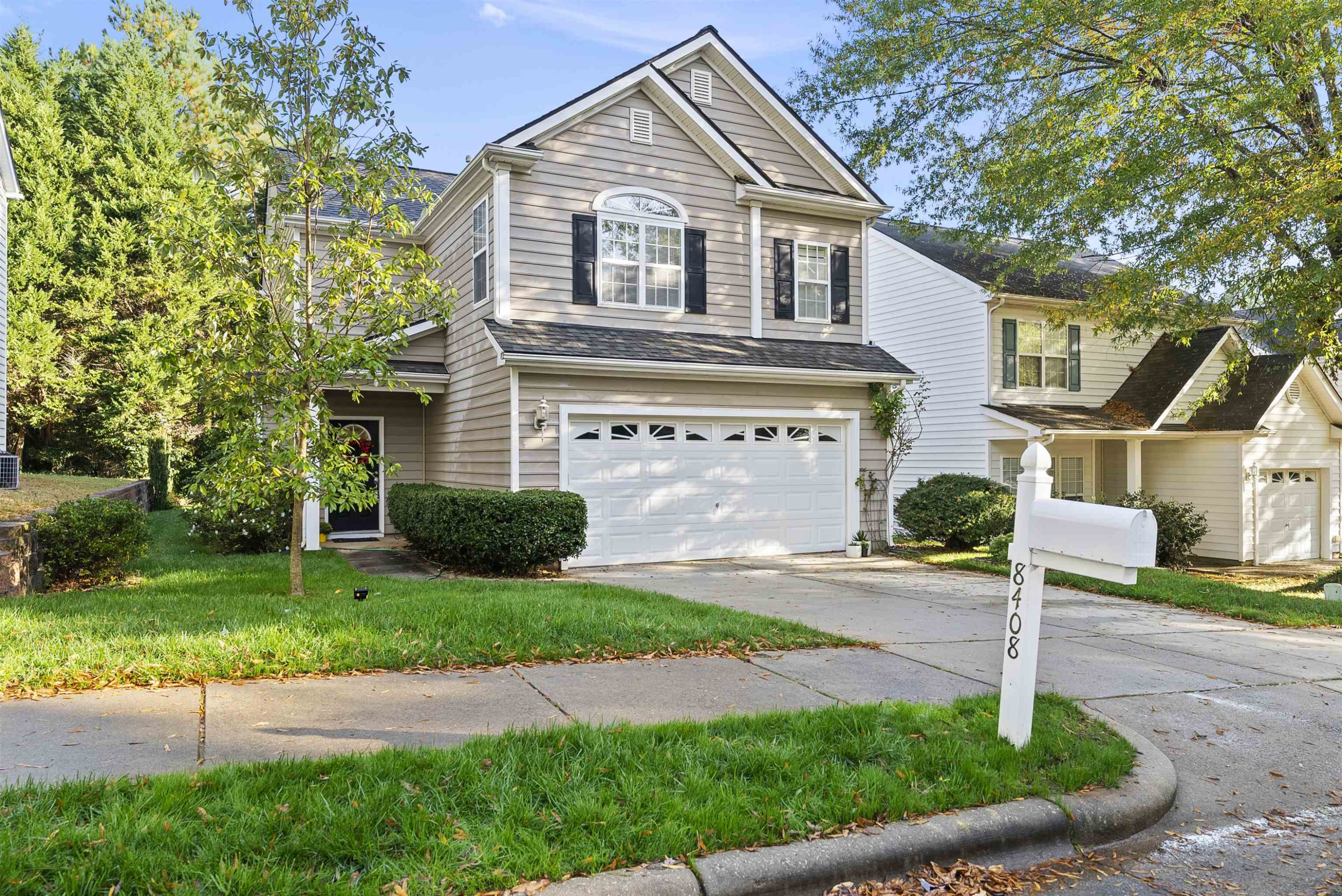 8408 Tie Stone Way Raleigh, NC 27613 - Photo 2 of 33 a front view of a house with a yard and garage
