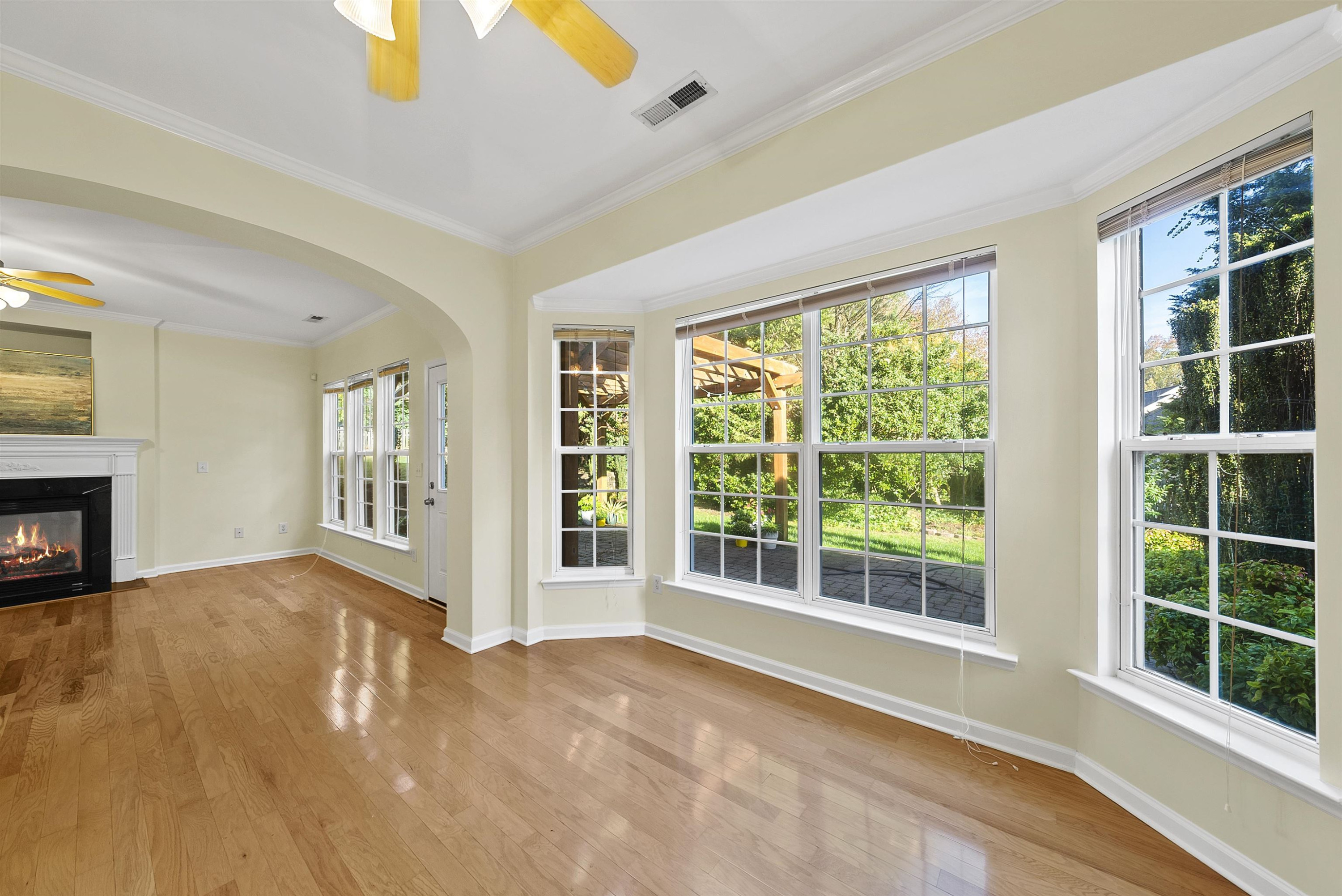 8408 Tie Stone Way Raleigh, NC 27613 - Photo 9 of 33 a view of an empty room with windows and a fireplace
