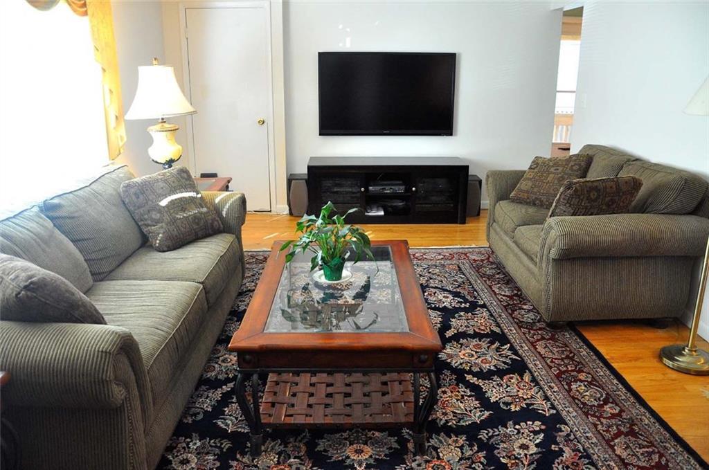 33 Dora Street, Unit 1 Stamford, CT 06902 - Photo 1 of 1 a living room with furniture and a flat screen tv